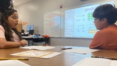 Students discussing a visual together in the classroom.