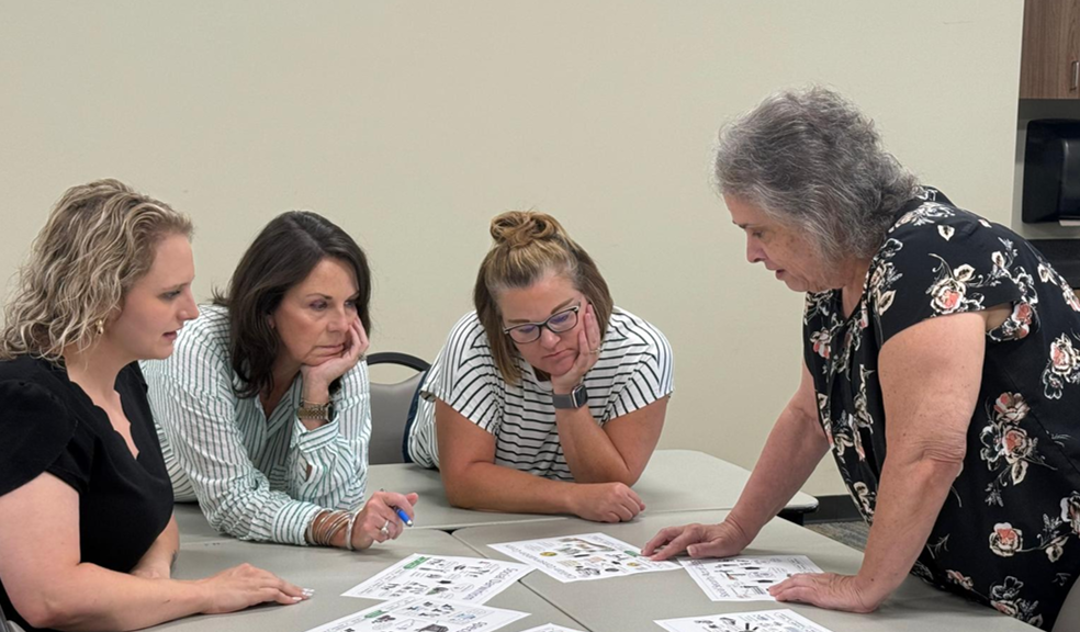 Teachers collaborating around instructional materials.