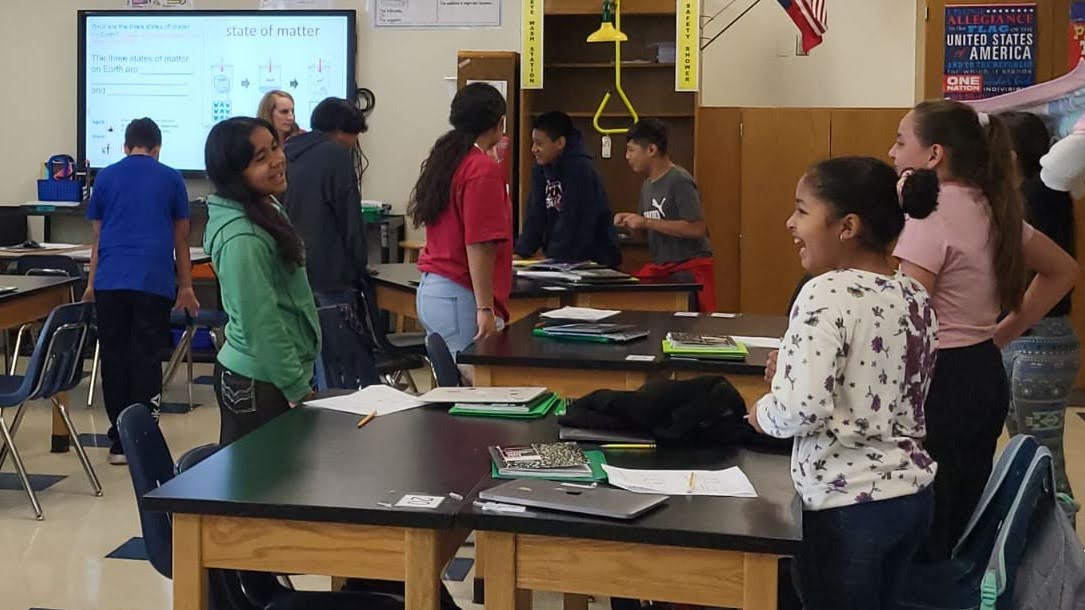 Students discussing a lesson together in their classroom